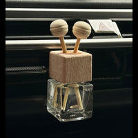 Car air freshener with wooden design on a car dashboard