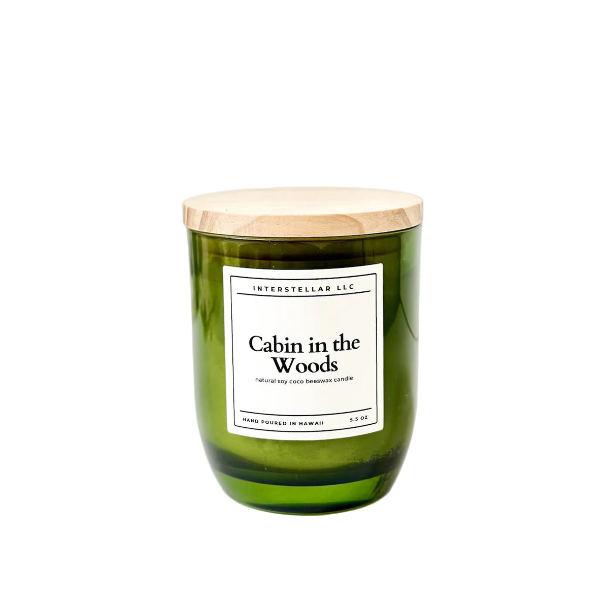 Green candle with a wooden lid labeled 'Cabin in the Woods' on a white background