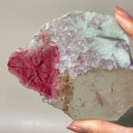 tourmaline lepidolite slice in hand